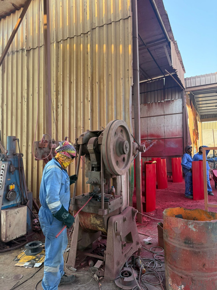 Operator running a hydraulic press machine in the workshop