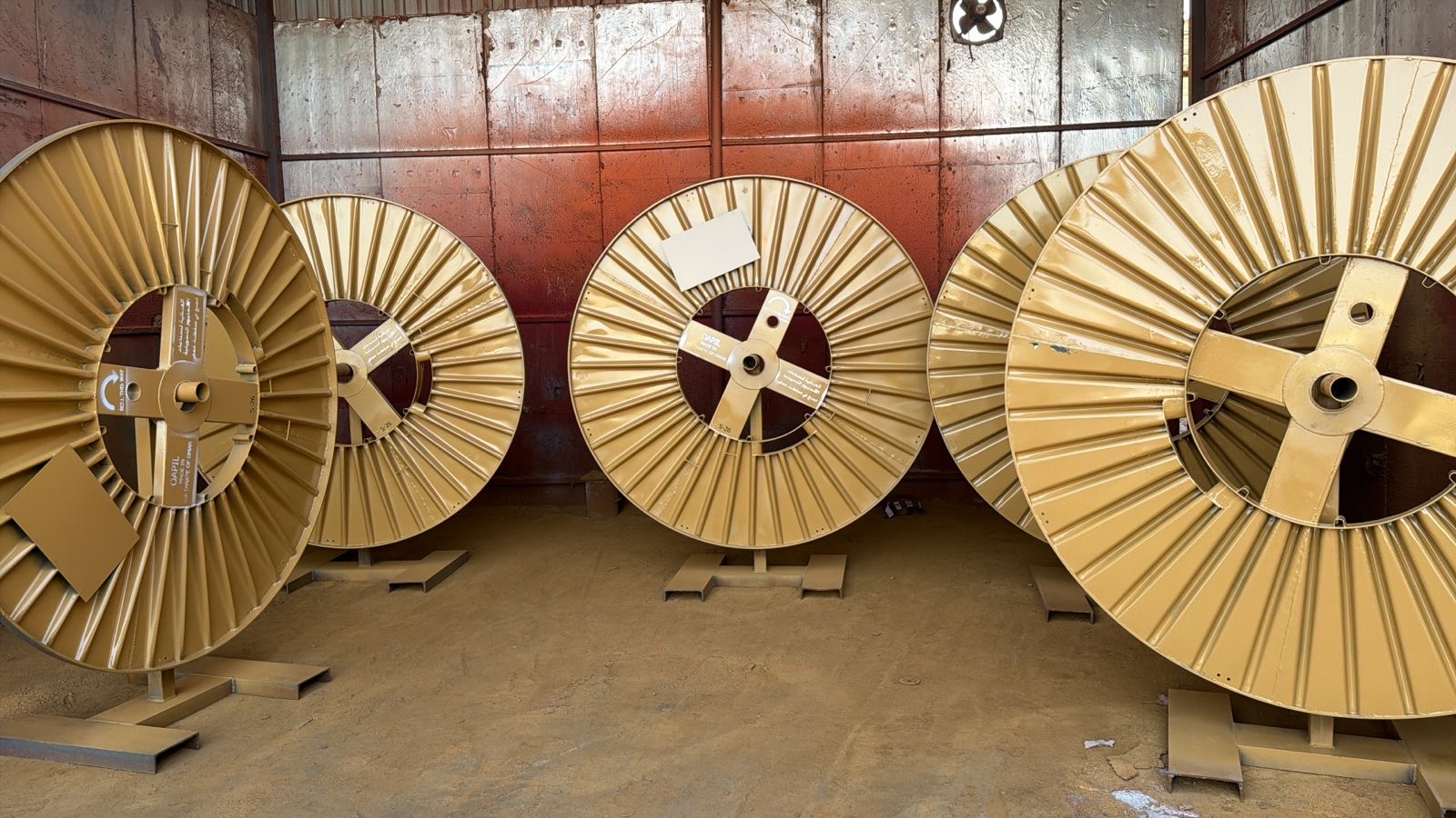 Gold coated steel cable reels inside the workshop