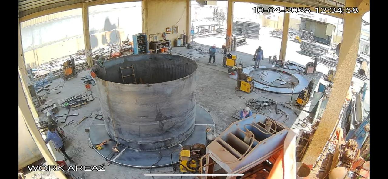 Overhead view of the Suba Engineering workshop floor with workers and steel drums